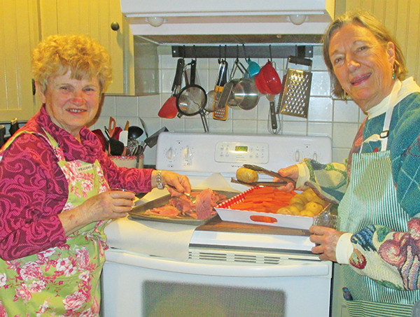 Chief chefs Sandy Warhol and Josie Thorpe, from left, do a trial run on cooking the beef and vegetables. Photo by Betty Wrenn Day