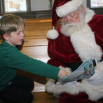 Asher Nazak, 6, with Santa going over what he wants