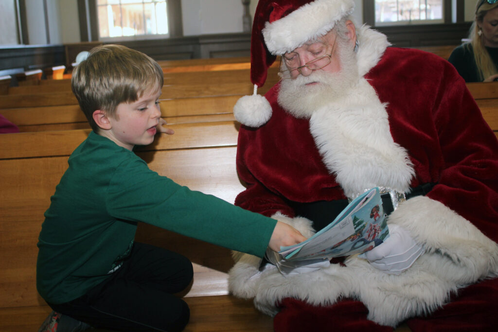 Asher Nazak, 6, with Santa going over what he wants