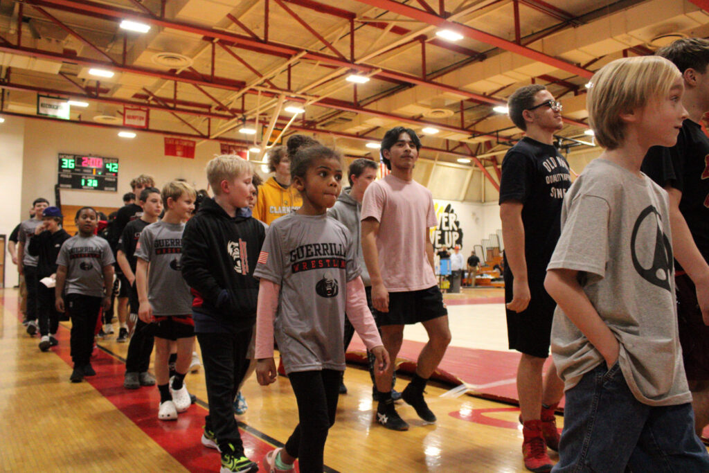 RUBY WILLIAMS / GAZETTE-JOURNAL Members of Guerrilla Wrestling escort the Gloucester High School wrestling team onto the mat before the Dukes competed against the Phoebus Phantoms.